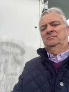 Mayor Cllr Tudor Thomas pictured in front of graffiti left on a town wall