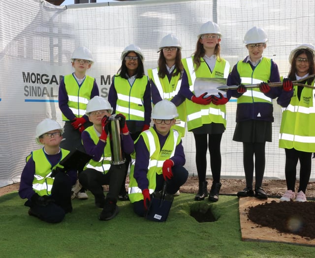 Children bury a time capsule on new 
school site in Abergavenny