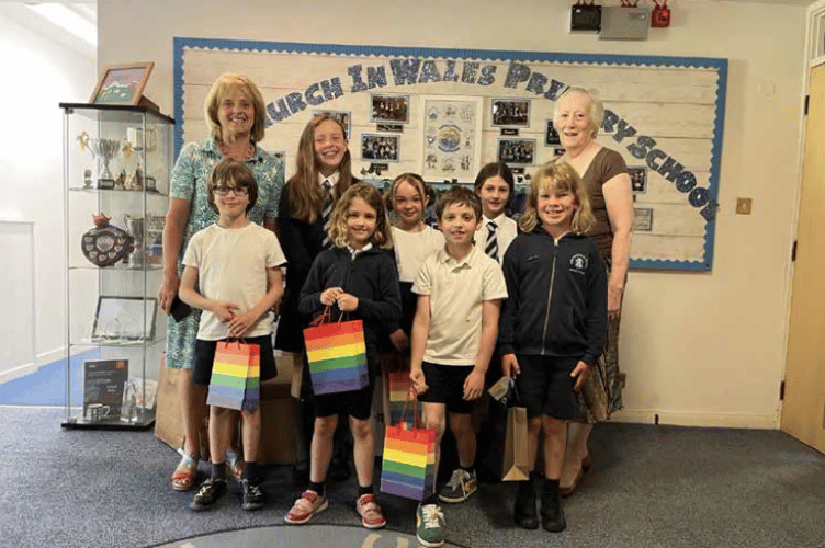 Writing competition prizewinners are pictured with ulie McGowan and Penny Reeves. The children are: back row from left: Carys Lee, Scarlett Nichols and Nell Back. Front row from left: Eddie Back, Ella James, Theo Gourdie and Ellis Wyatt.