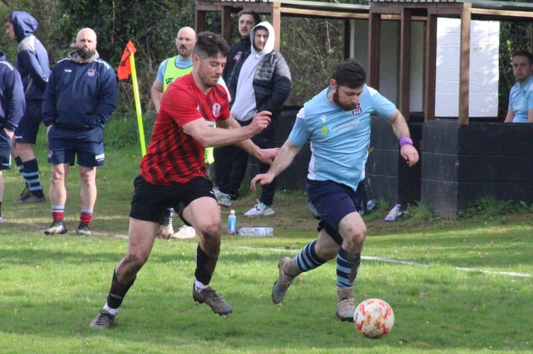 A Crickhowell player chases a Cwmcarn player