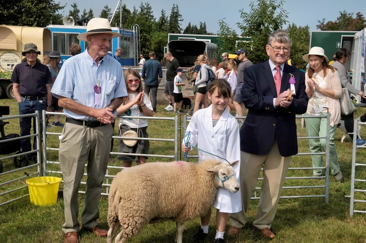 Young handler Eleanor Herbert with judge Lyndon Edwards and show committee member John Jenkins