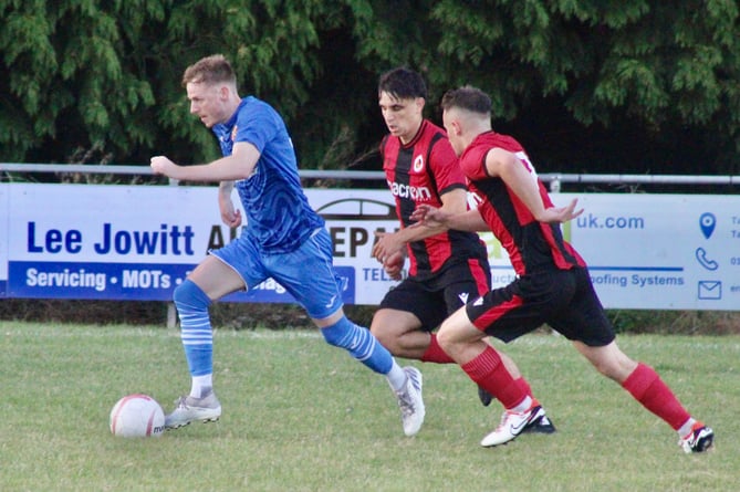 An Abergavenny player escapes two Goytre defenders