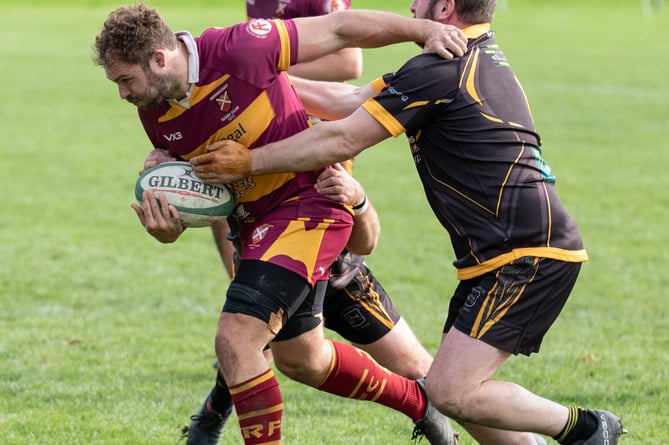 An Aber player tries to charge through