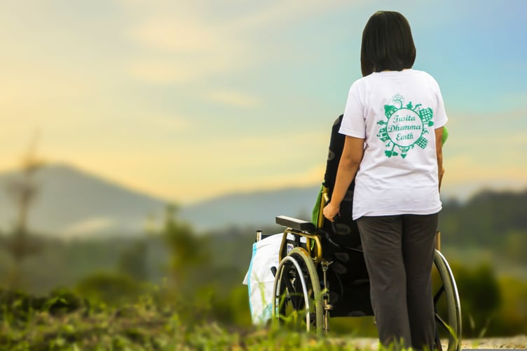 Woman pushing wheelchair