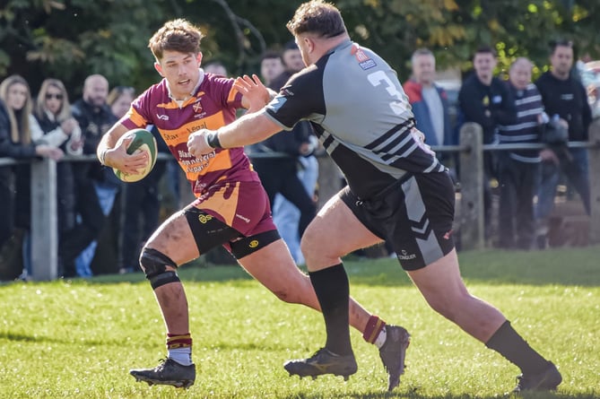 An Abergavenny player bursts through