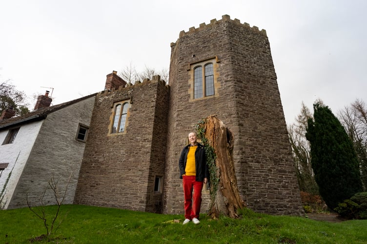 Mok by the cherry tree where Gladys is buried. A man bought a historical Â£1m castle - only to discover the previous owner is buried in the garden. History enthusiast Mok O'Keeffe, 55, purchased his five-bed Elizabethan castle in 2021 with husband Joe Magle, 37. Mok researched the history of the Grade II listed building before moving in, learning it had once been a school, as well as a WWII prisoner of war camp. But he didn't learn until after moving in that Gladys Atkins, born around 1898, requested her ashes be buried in a cherry tree in the garden of her childhood home when she died in 1995, aged 97. Abergavenny, Wales. December 16 2024.