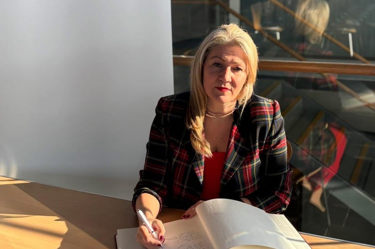 Laura Anne Jones (CON, South Wales East) signs Book of Commitment in the Senedd.